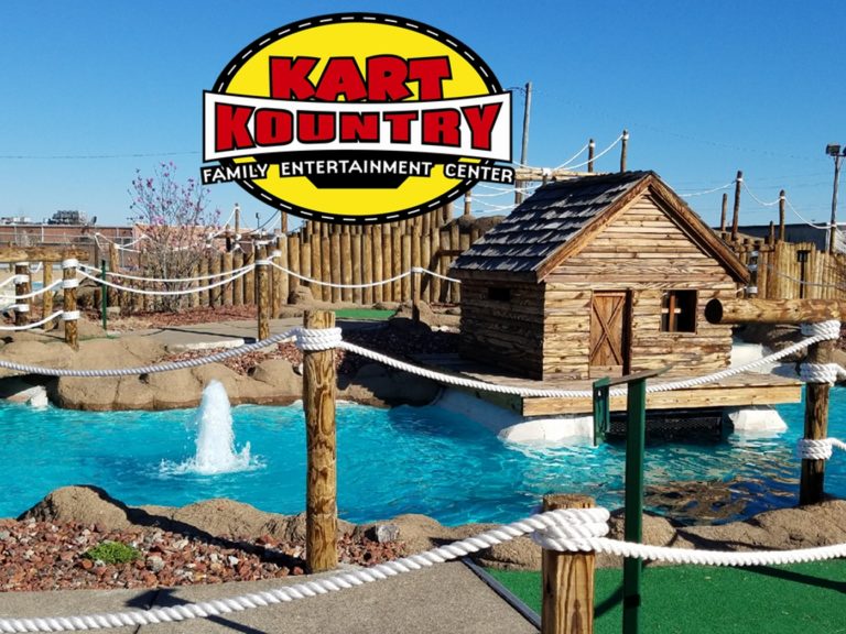 The Volcano miniature golf course with a log cabin and water fountain
